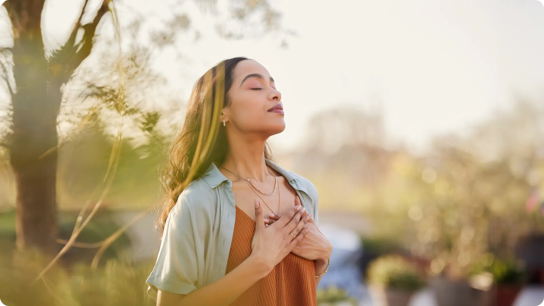 woman inhaling doing a breathing exercise to de-stress