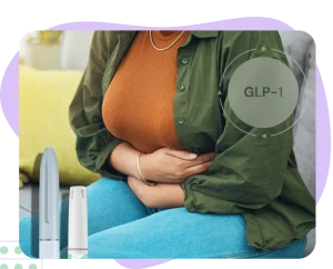 Woman holding stomach suffering from bloating due to GLP-1 treatment