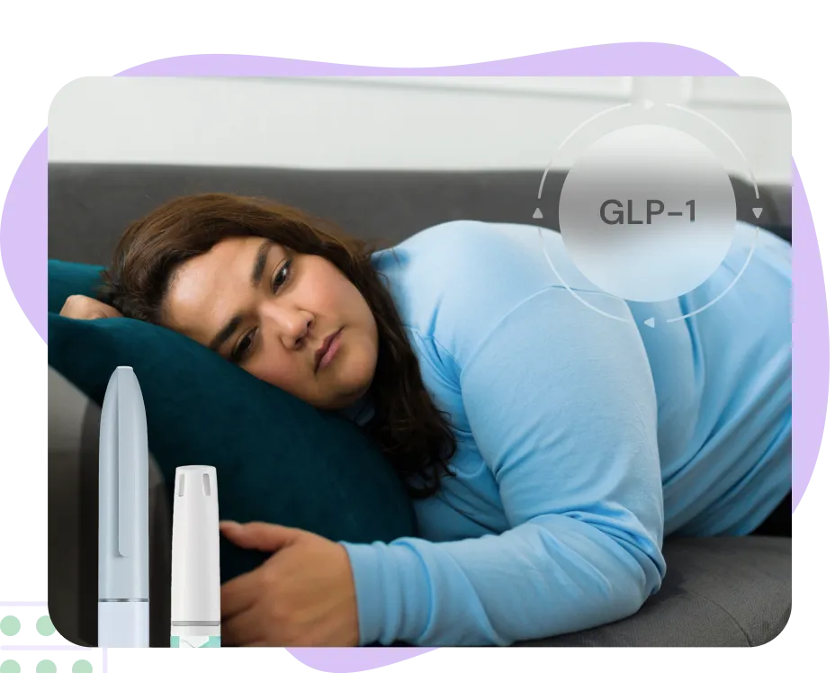 A woman looking sleepy, lying on the sofa with bags under her eyes.